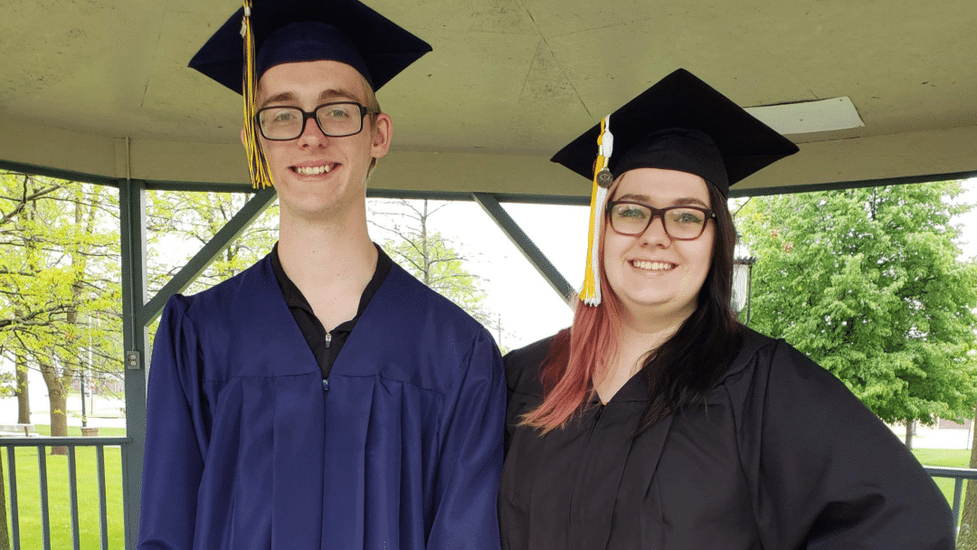 male graduate and a female graduate standing next to each other