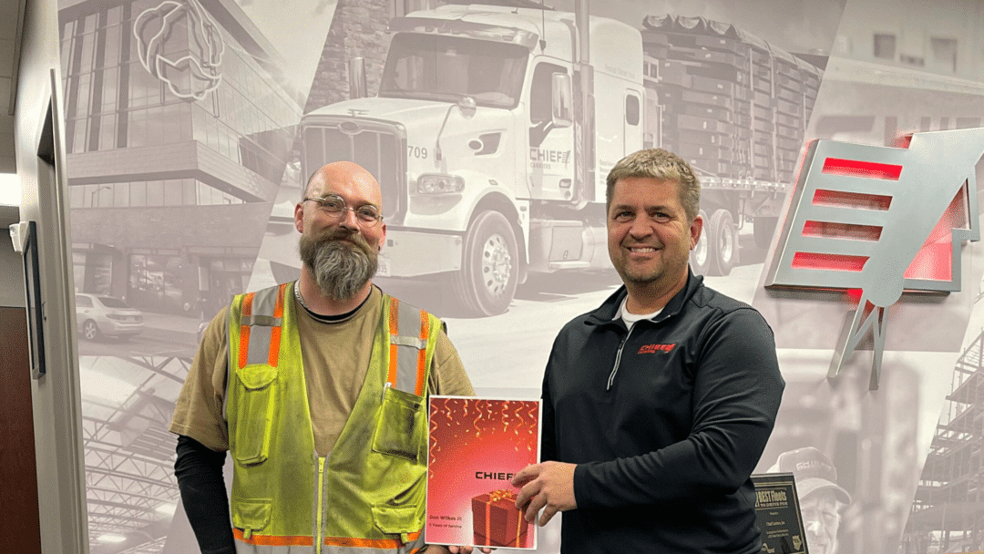 two men receiving an award from a trucking company in nebraska