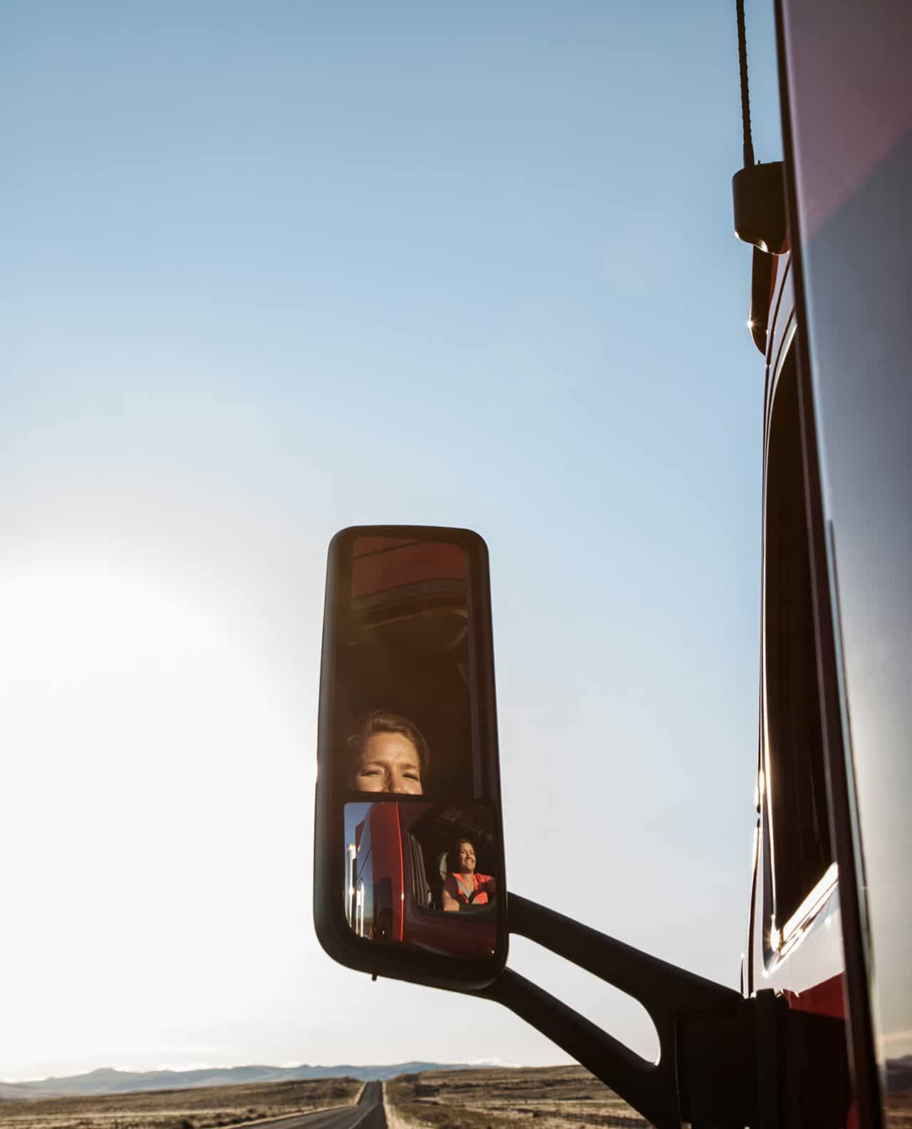 View of a Caucasian woman driver in the cab of her commercial truck