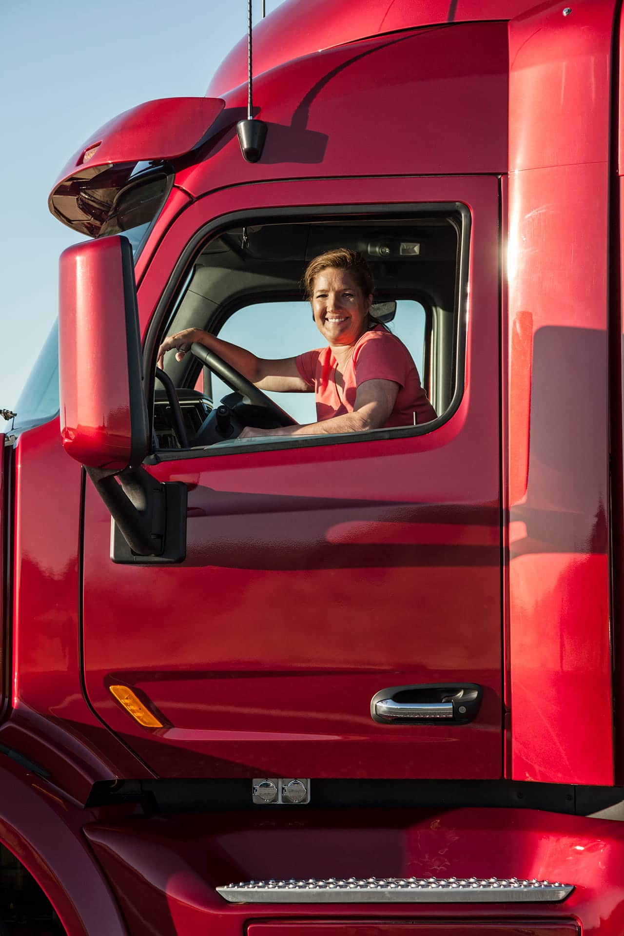 Portrait of a Caucasian woman driver and her commercial truck