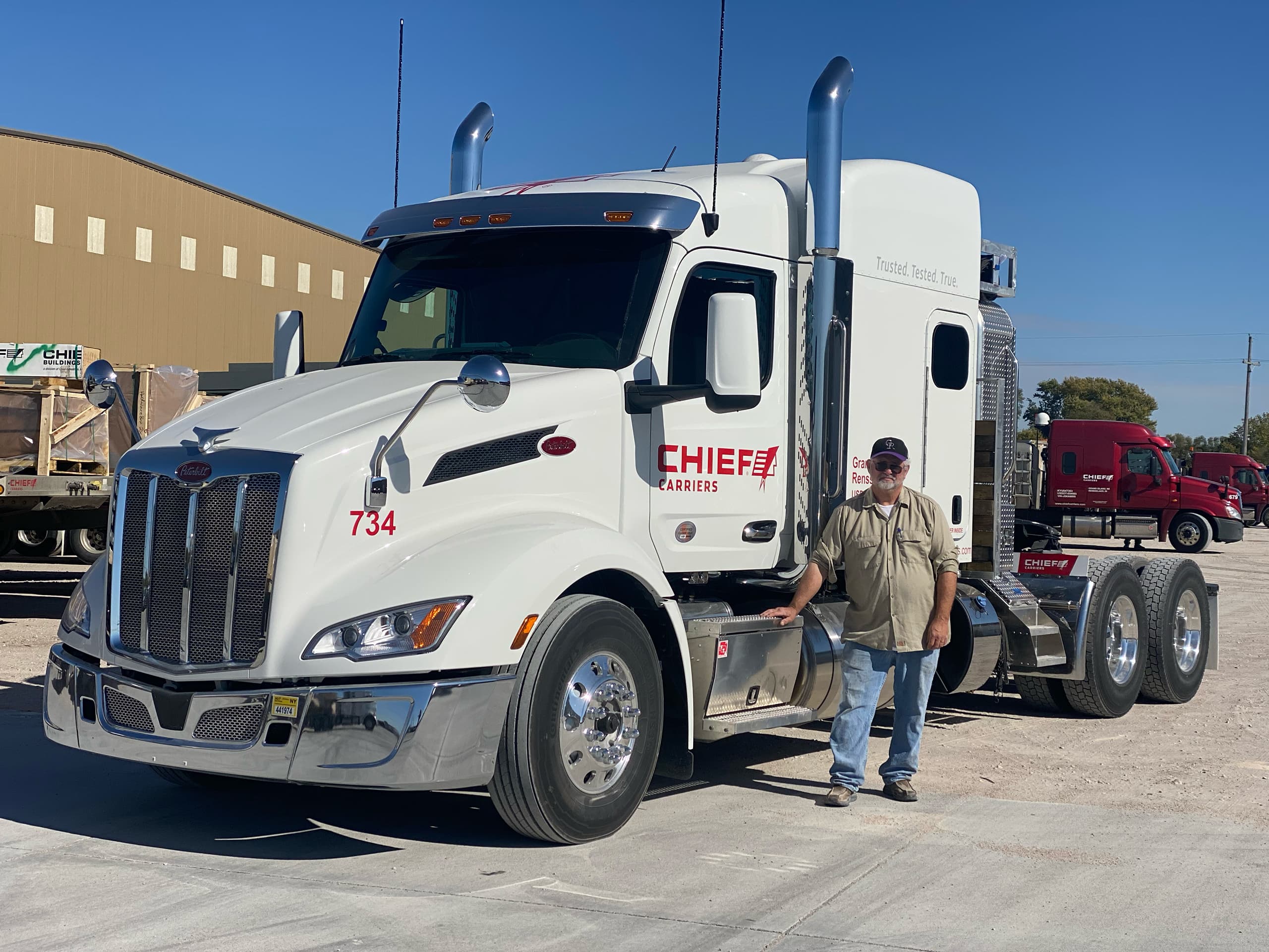 nebraska truck driver for chief carriers standing outside a white Chief Carriers semi