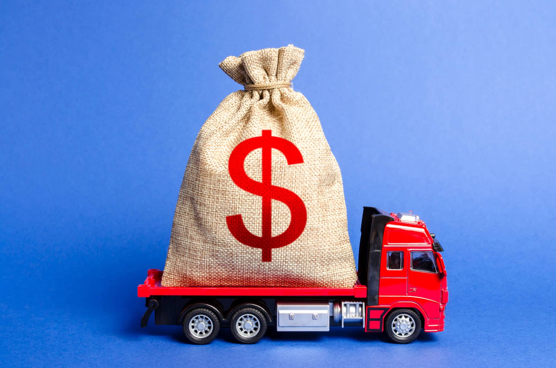 Red truck carries a big bag of money