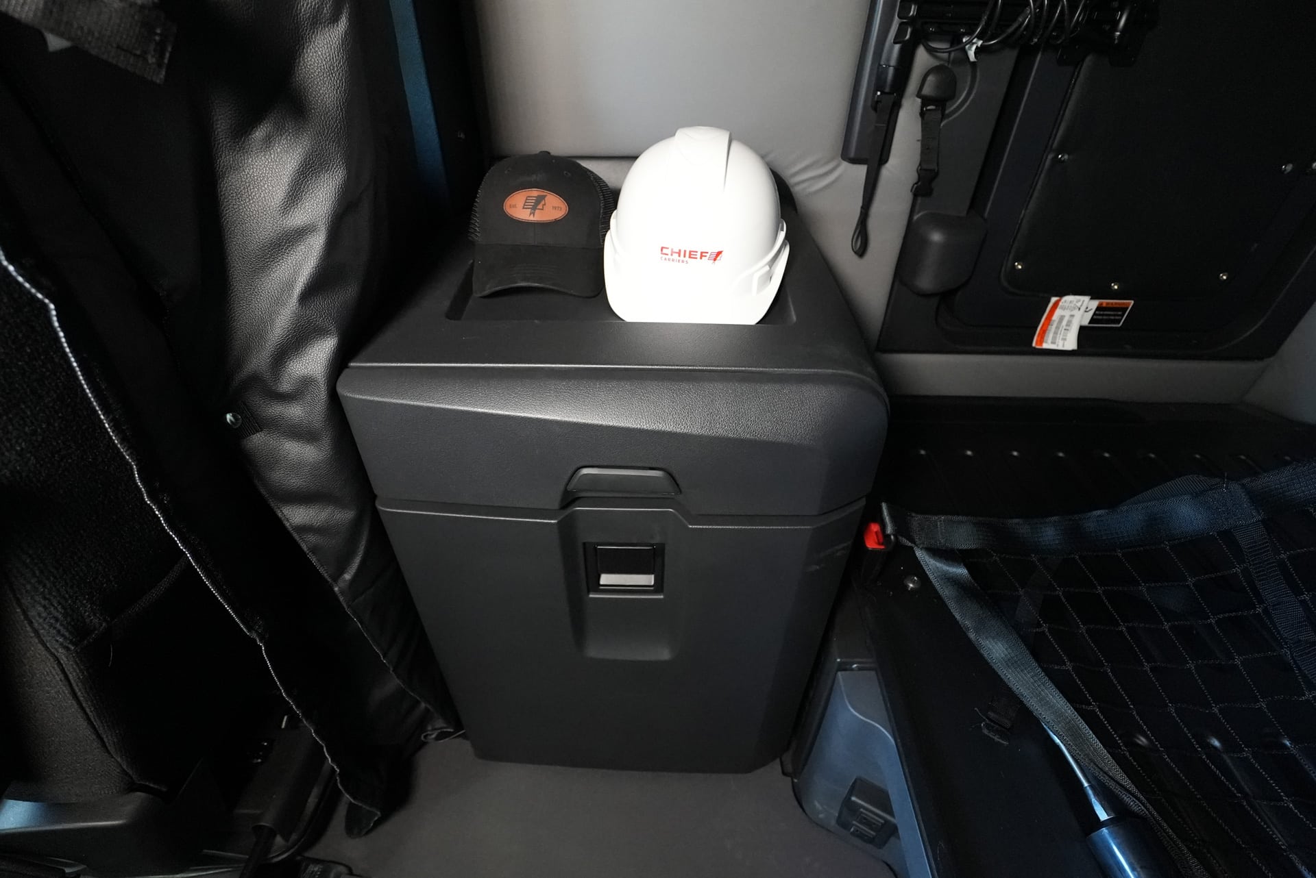 chief carriers hard had and baseball hat inside a freightliner