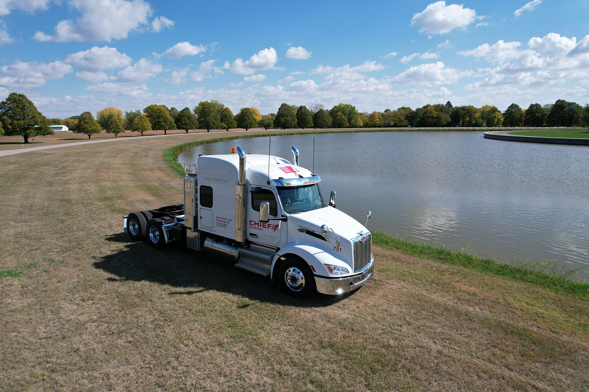 Chief Carriers semi cab next to an open body of water; captured by a drone