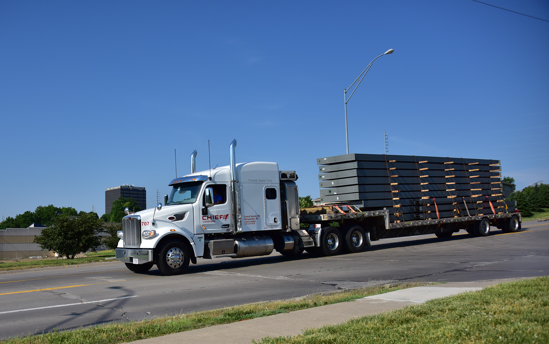 chief carriers semi with a flatbed trailer and full load on the road