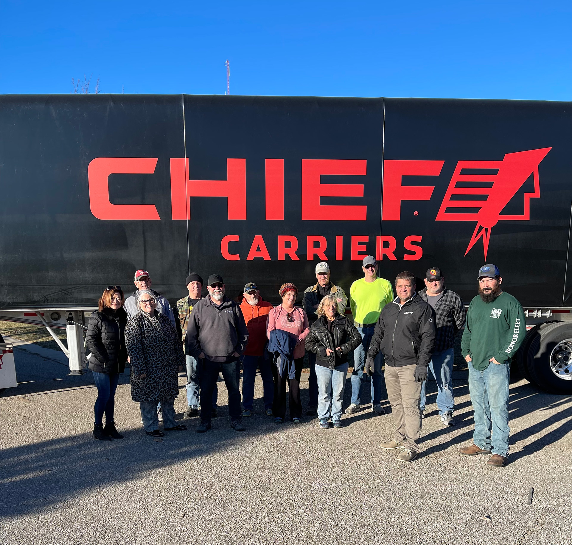 several nebraska truck drivers standing outside a chief carriers truck