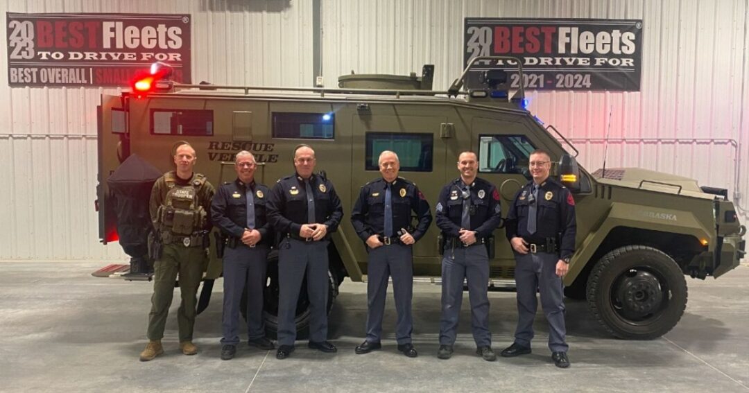 Members of the Nebraska State Patrol standing in front of a new BearCats vehicle