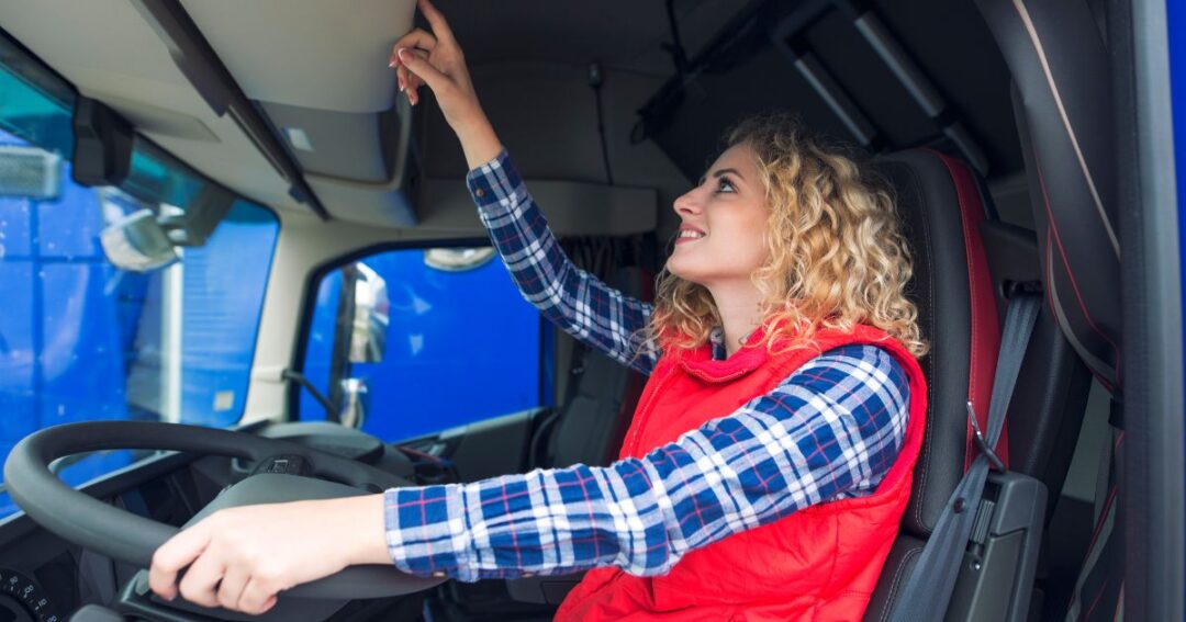 Woman truck driver behind the wheel