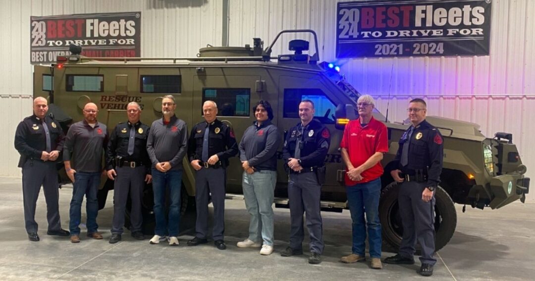 Members of Nebraska State Patrol and Chief Carriers with a BearCat behind them