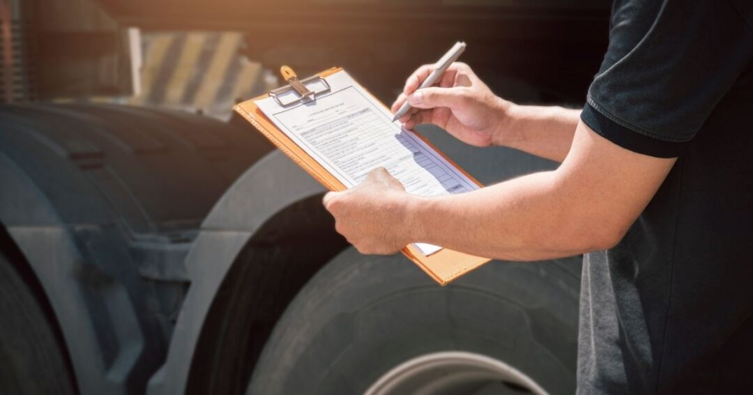 Man with clipboard making notes