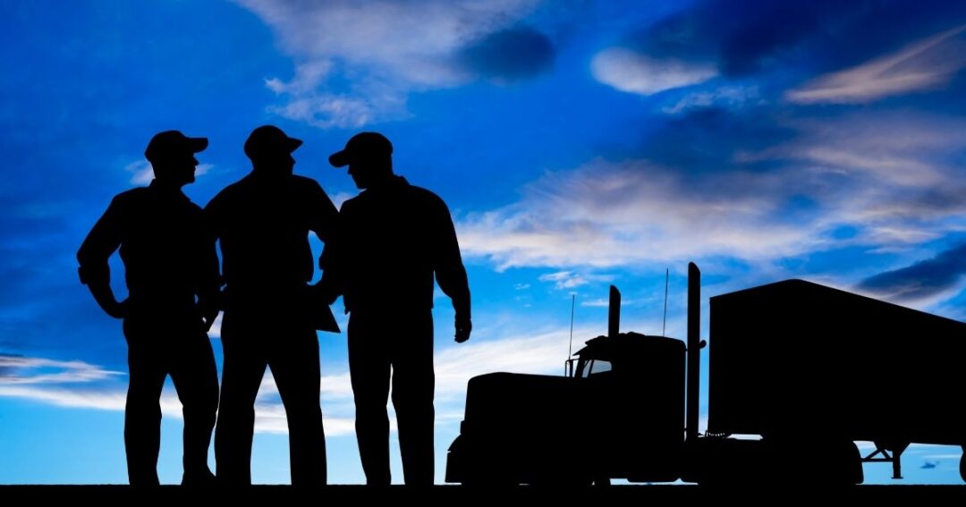 Silhouetted image of three men and a semi-truck. Lease Operator pay