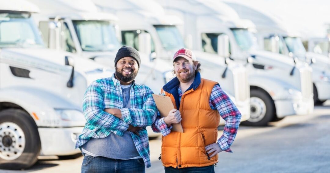 Two smiling truck drivers