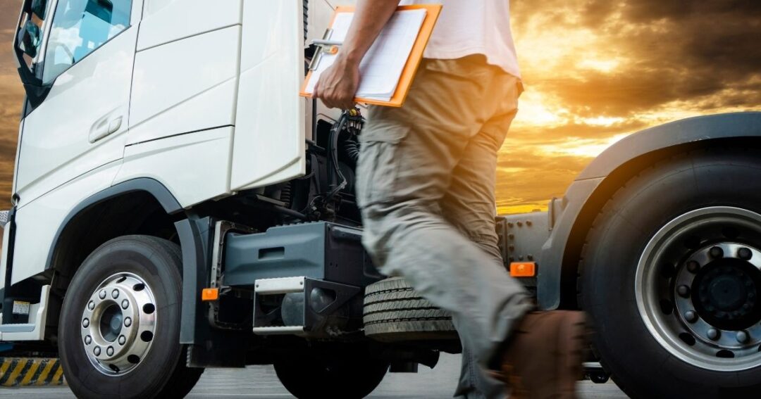 A truck driver carrying paperwork. Lease purchase trucking