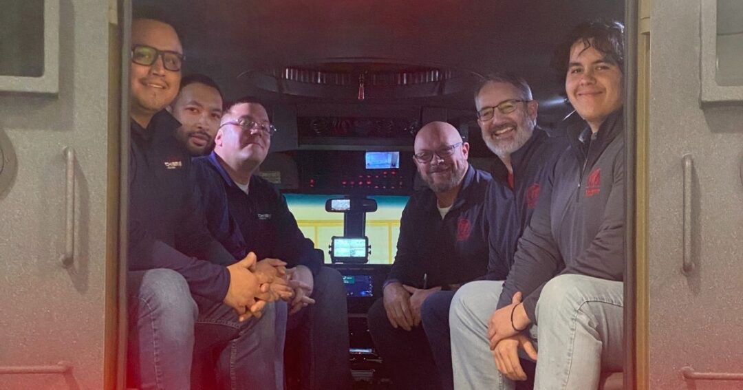 Members of Chief Carriers and Chief Logistics seated inside the Nebraska State Patrol BearCats vehicle