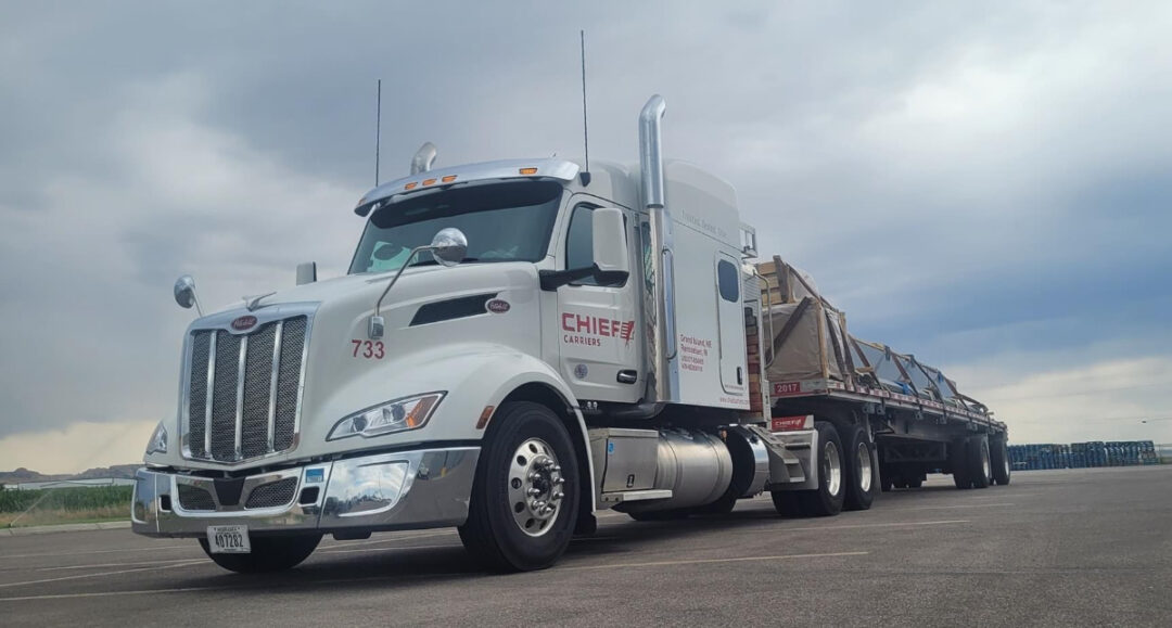 Low-angle view of a Chief Carriers flatbed truck.