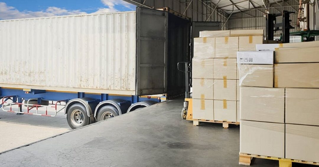 A semi-truck parked at a loading dock.