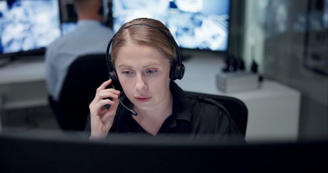 A female dispatcher talking on a headset.