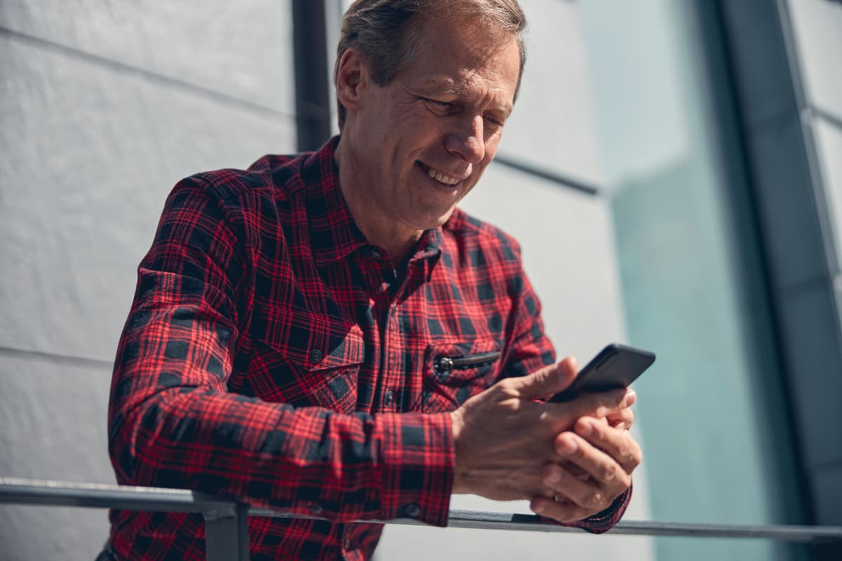 A man using his smartphone to find safe truck parking.