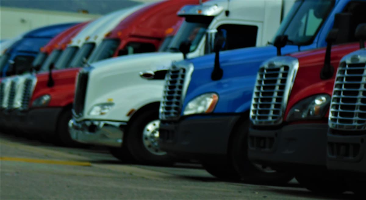 A row of parked semi trucks.