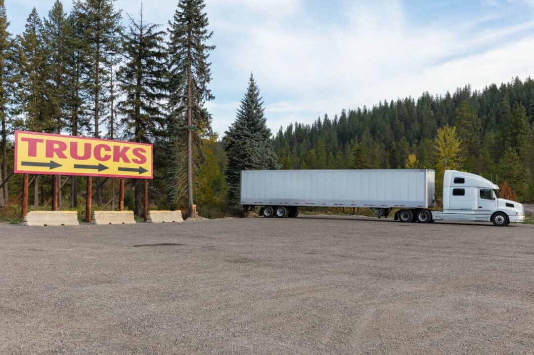 A basic gravel lot for big rig truck parking.
