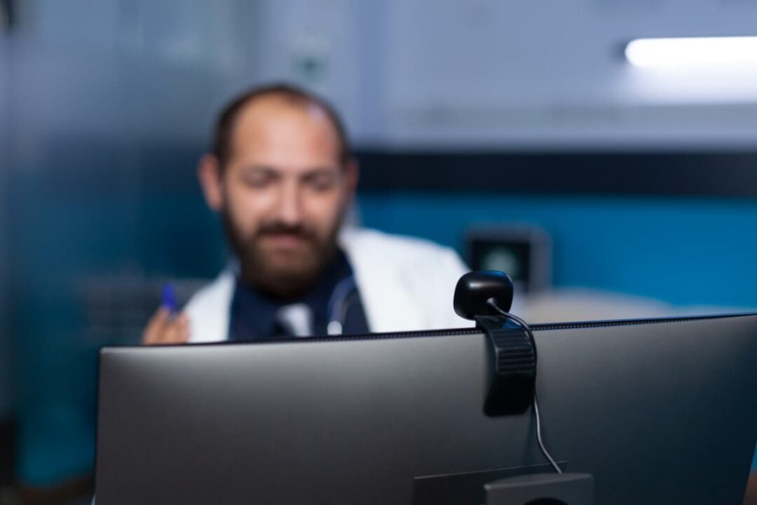 Closeup of a webcam on a monitor used for telehealth services.