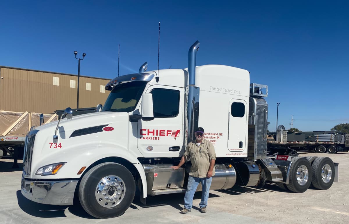 Driver standing next to a Chief Carriers truck.