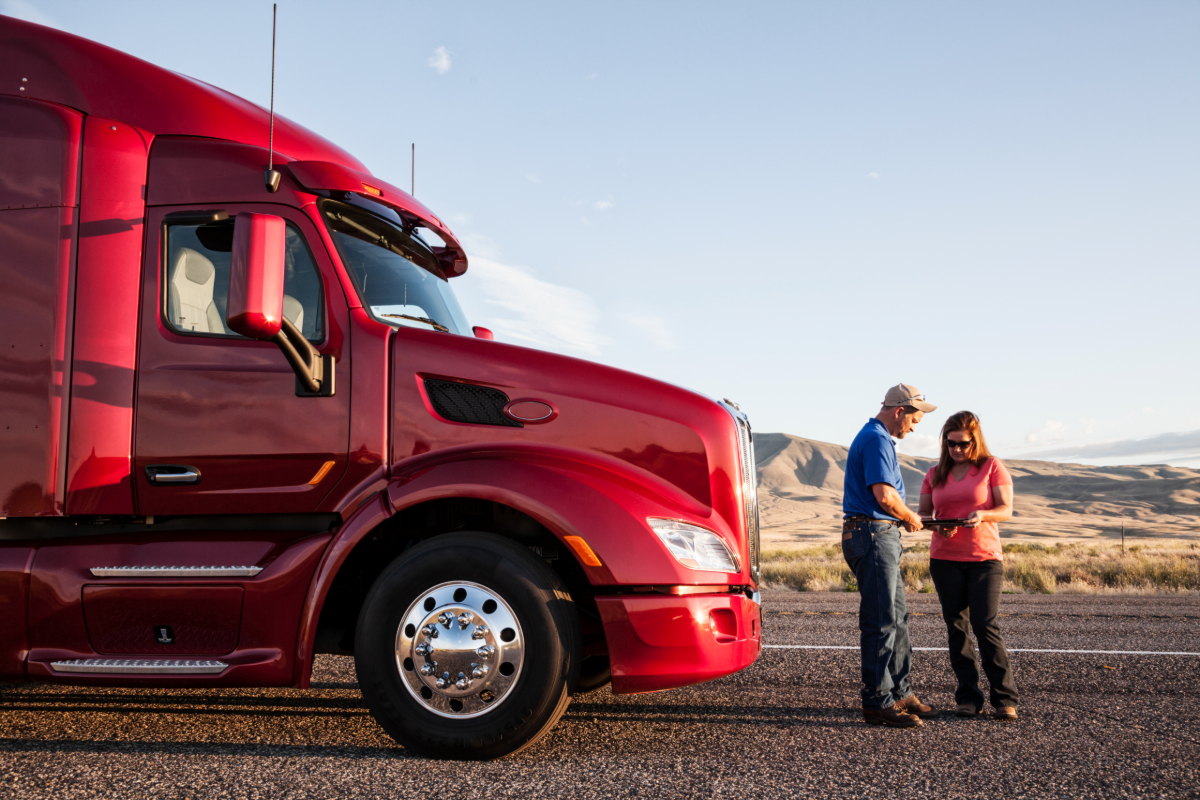 A husband and wife truck driving team planning a safe truck parking spot for the night.
