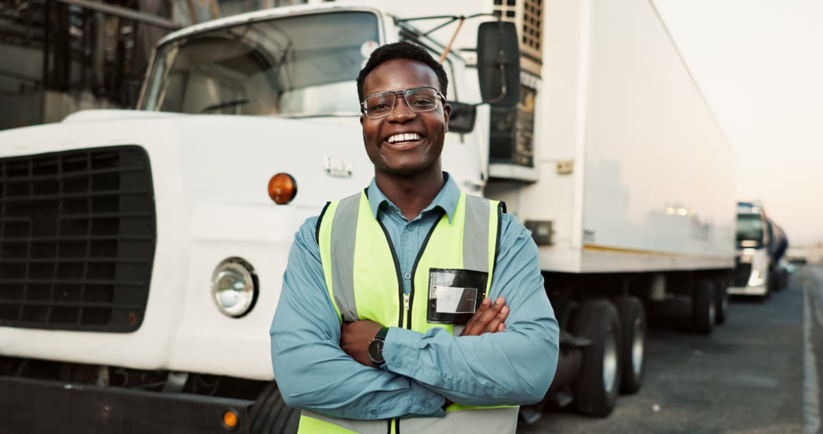 A smiling, happy commercial truck driver.