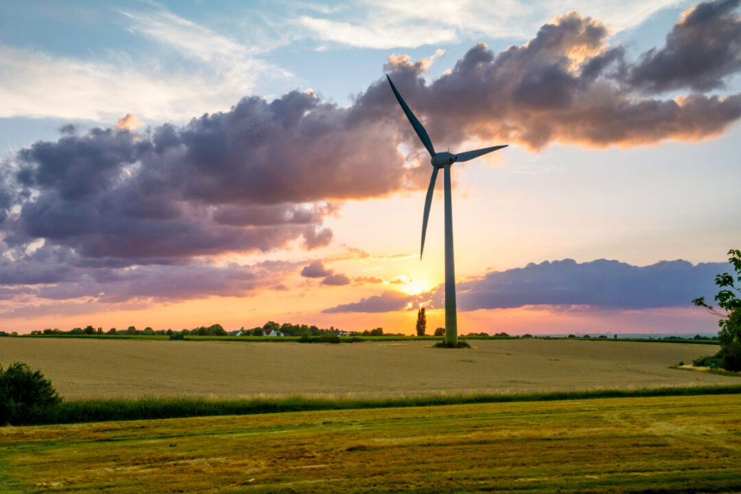 A windmill in an agricultural field.