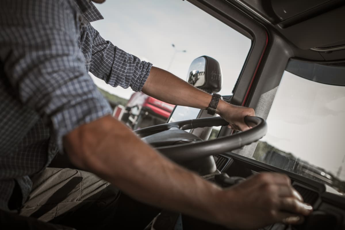 An unidentified man behind the wheel of a commercial big rig.
