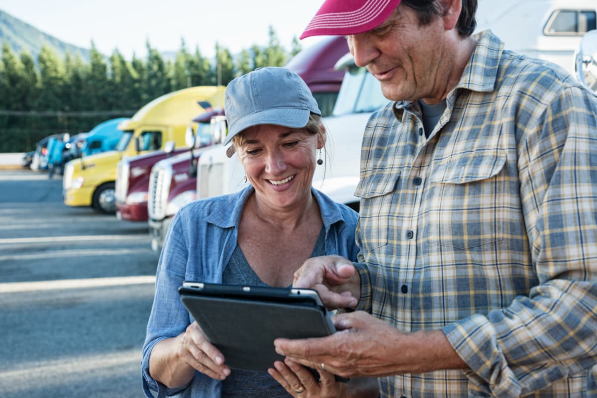 Two truck drivers discussing paperwork.