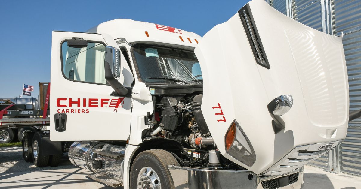 A white Chief Carriers truck with the hood lifted.
