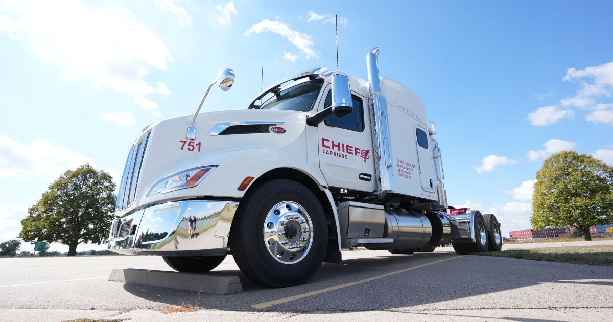 Low-angle view of a white Chief Carriers truck.
