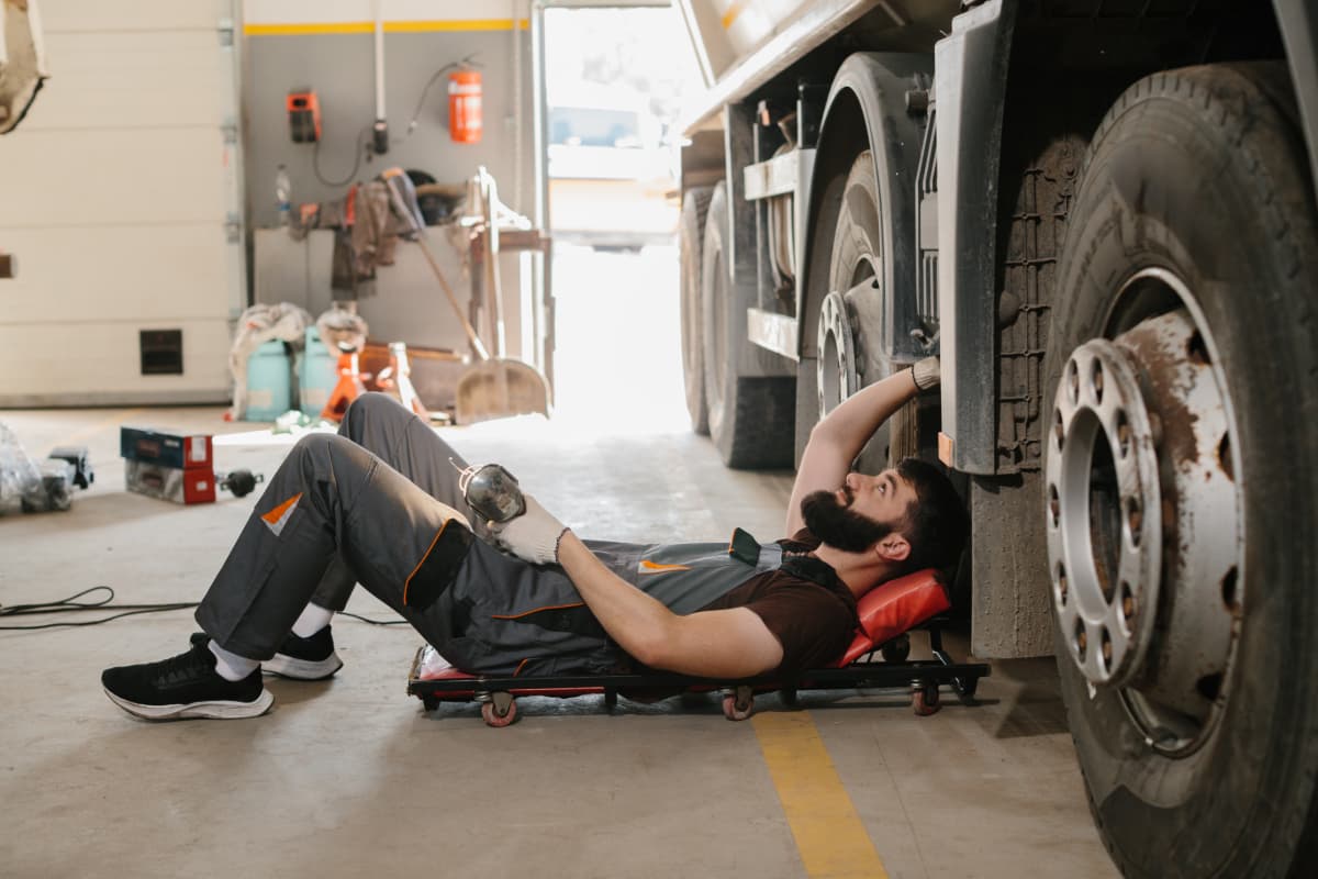 A mechanic working on a large commercial diesel truck