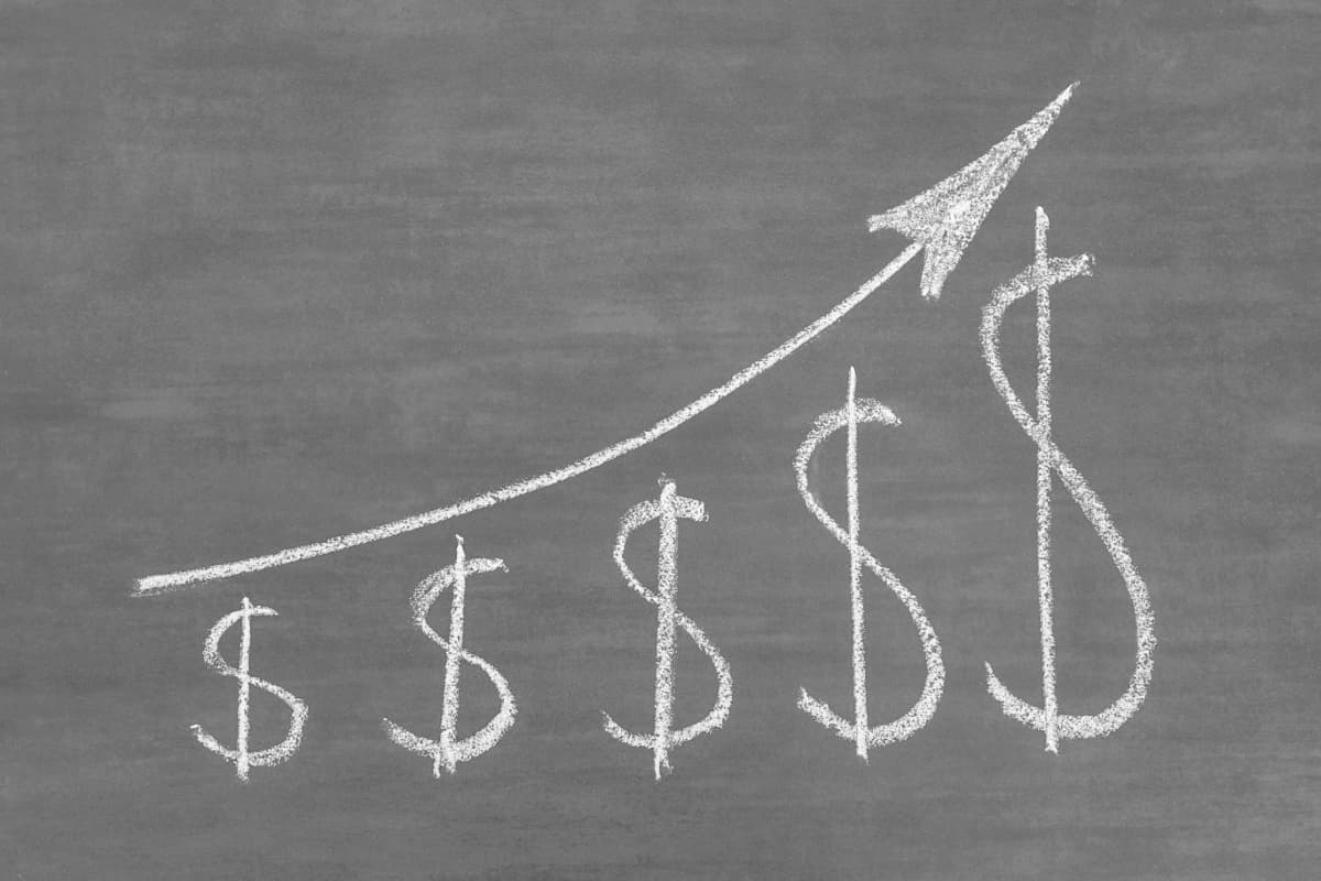 A chalk drawing illustrating sharply rising costs over time.