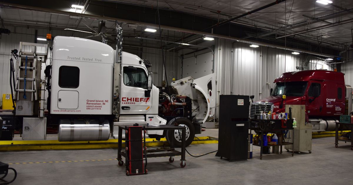 Two Chief Carriers trucks in undergoing maintenance.
