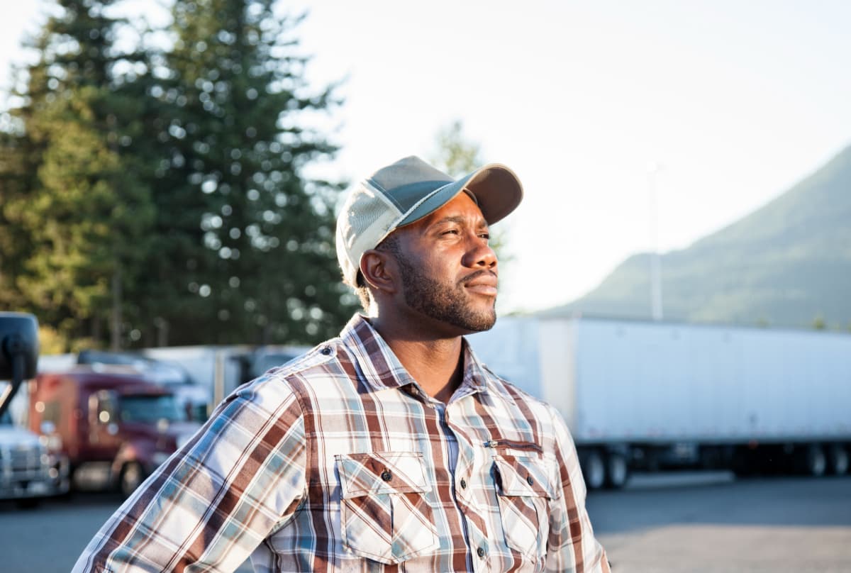 A young male truck driver at a truck stop.