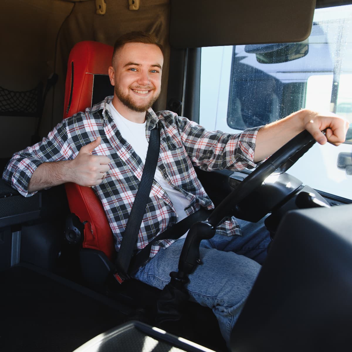 A smiling young male truck driver.