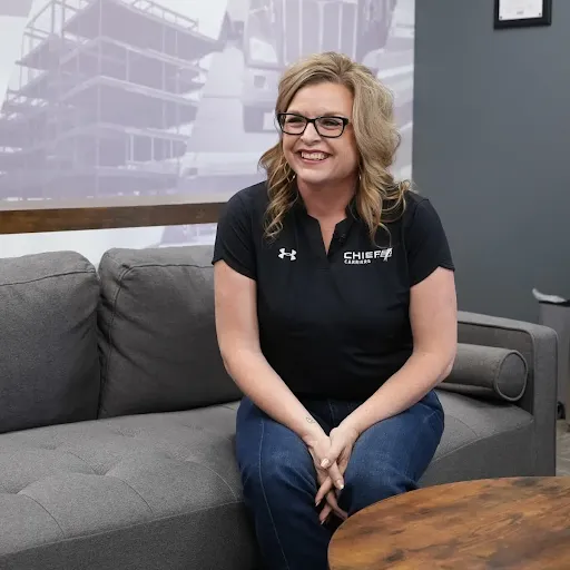Chief Carriers employee smiling on a couch.