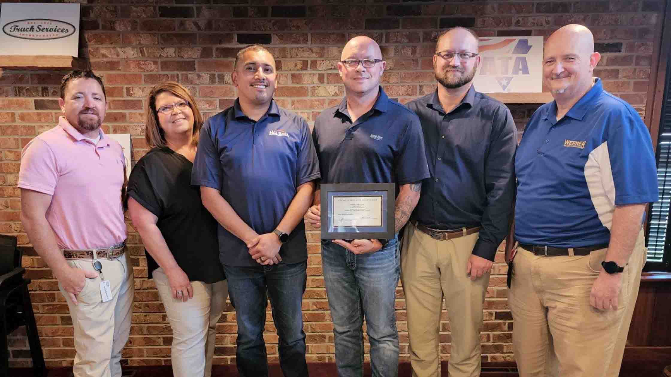 Nebraska-Trucking-Association six men and women standing holding an award