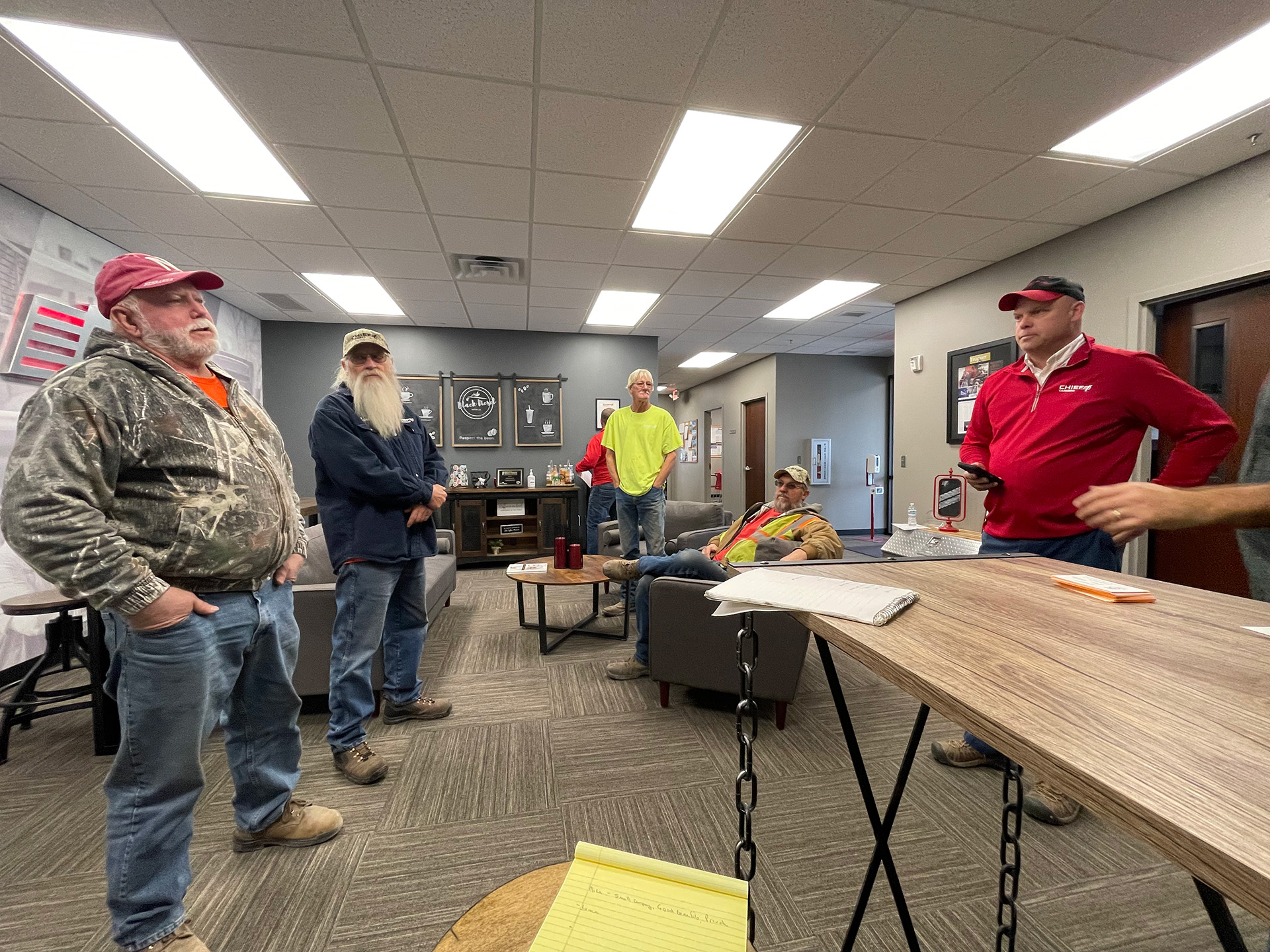 several drivers at Chief Carriers in a conference room for their driver safety meeting