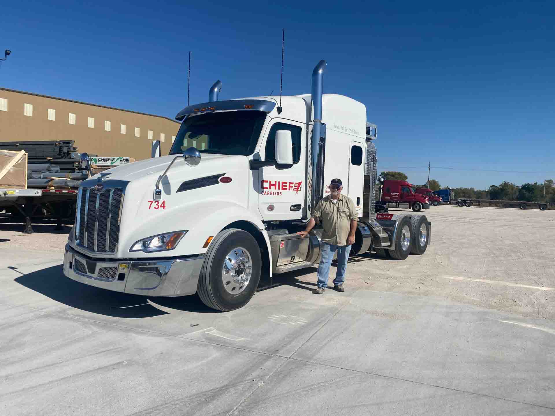 Grand Island trucking company driver standing in front of his white Chief Carriers semi